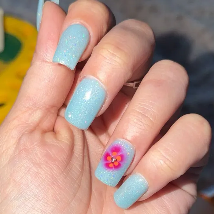 Short baby blue nails with a hand-painted pink flower accent nail