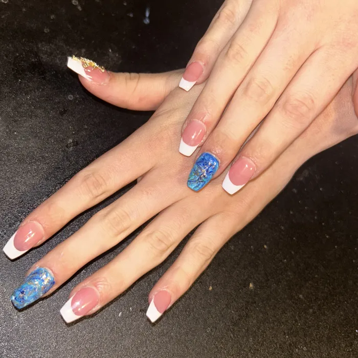 Long coffin French tips with blue glitter hand-painted accent nails