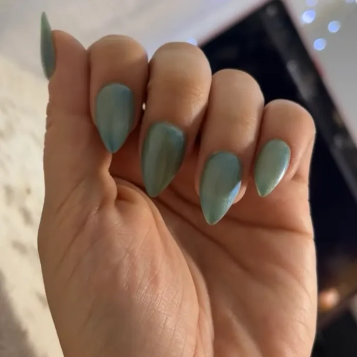 Long almond nails in a soft sage green gel